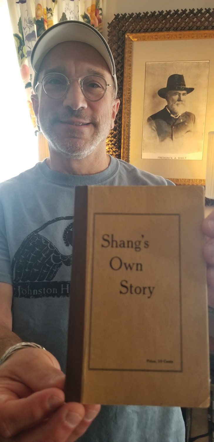 IN HIS WORDS: Anthony Ursillo holds a copy of Shang Bailey’s autobiography ‘Shang’s Own Story’ in the Hartford Avenue home where both men have resided, 100 years apart.